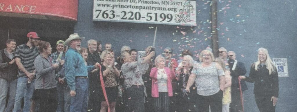 A group of volunteers celebrating outside the pantry.